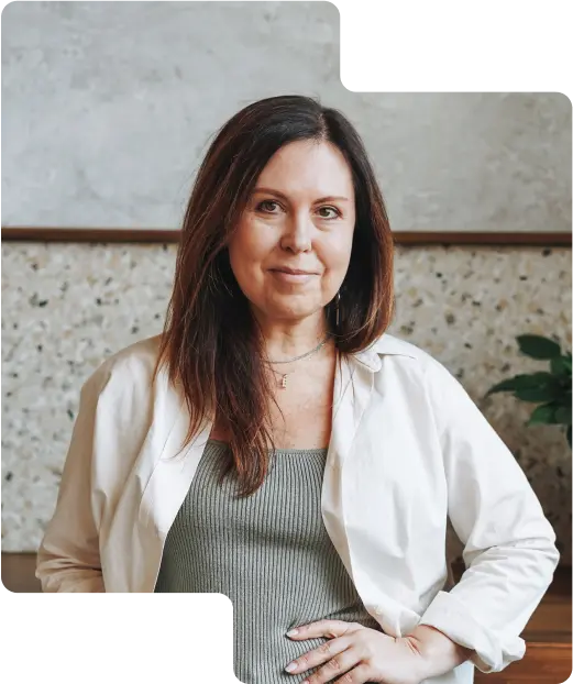 Contented customer photo showcasing a poised woman with shoulder-length hair and a subtle smile, wearing a white jacket over a green top, indicative of the diverse clientele who trust our cryptocurrency exchange services.